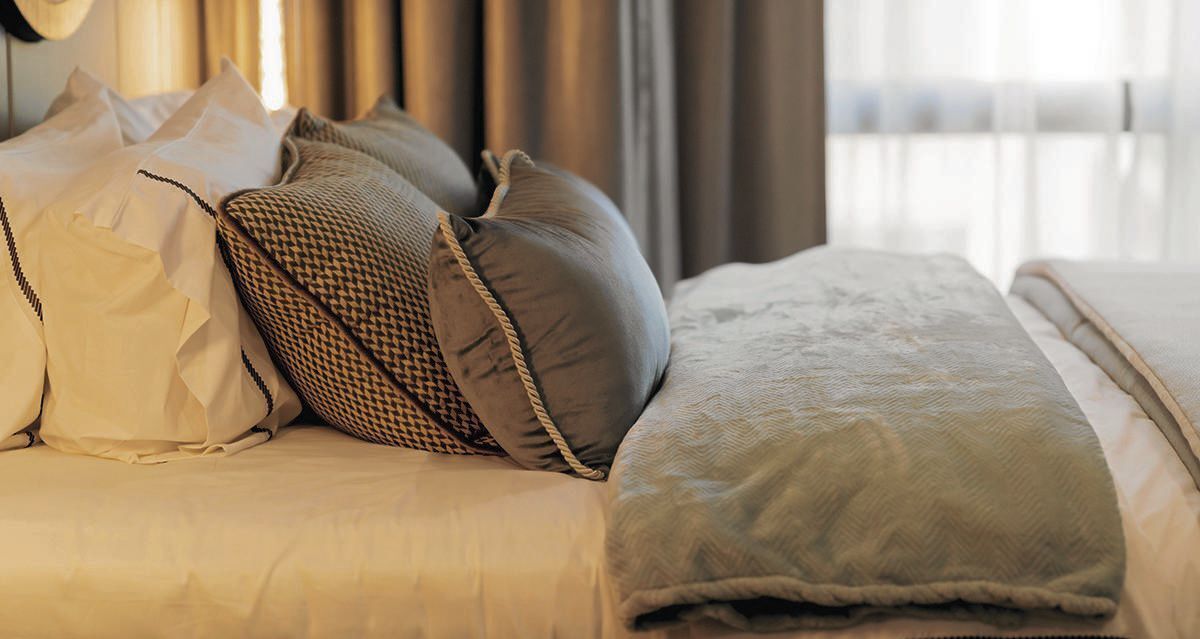 Pillows on bed in contemporary bedroom interior decorating ideas concept